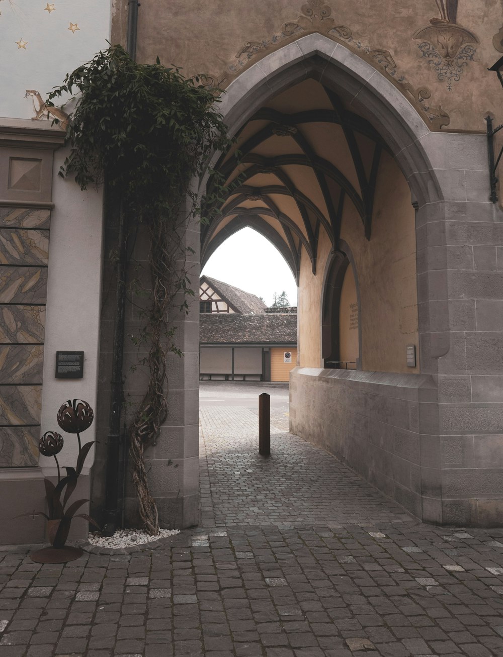 an archway leading to a building with a clock on it