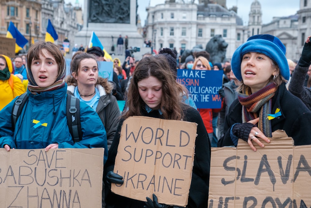 a group of people holding signs in a protest