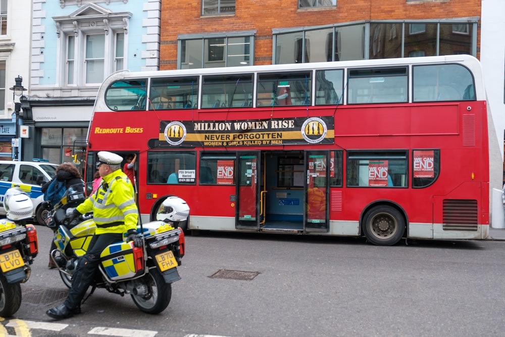 a red double decker bus driving down a street