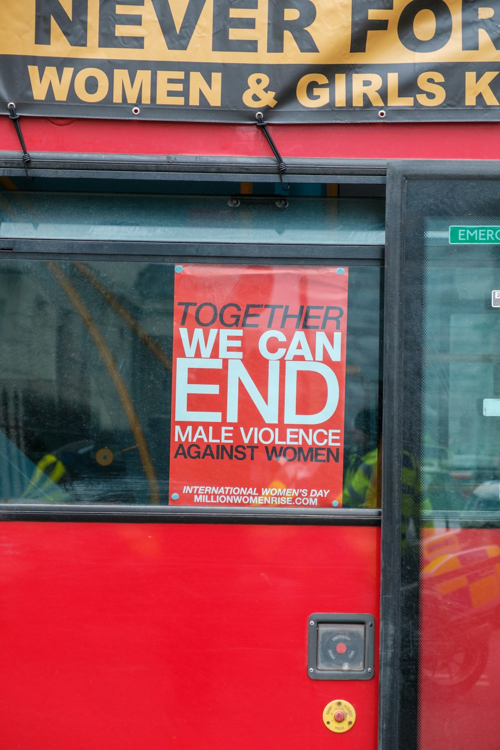 a red door with a sign that says we can end male violence against women