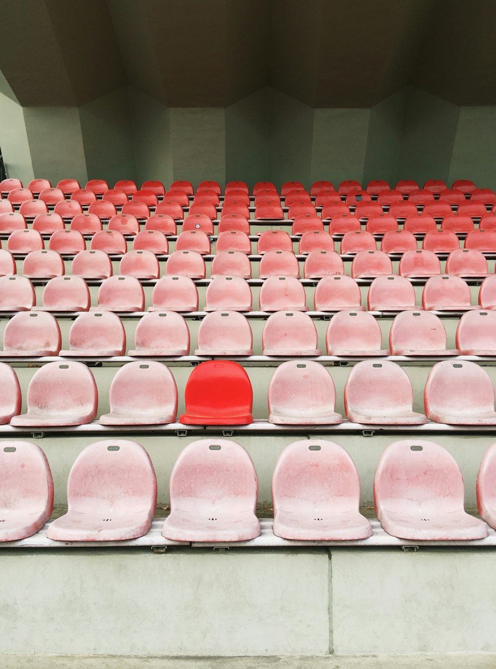 a row of red seats sitting next to each other