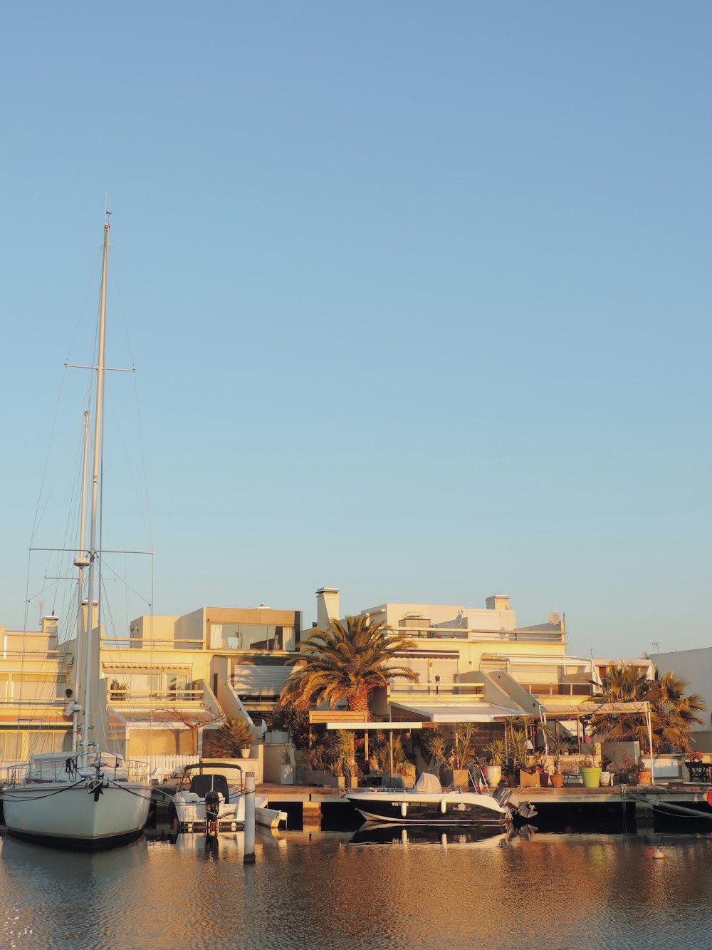 a sailboat docked in a harbor next to a building