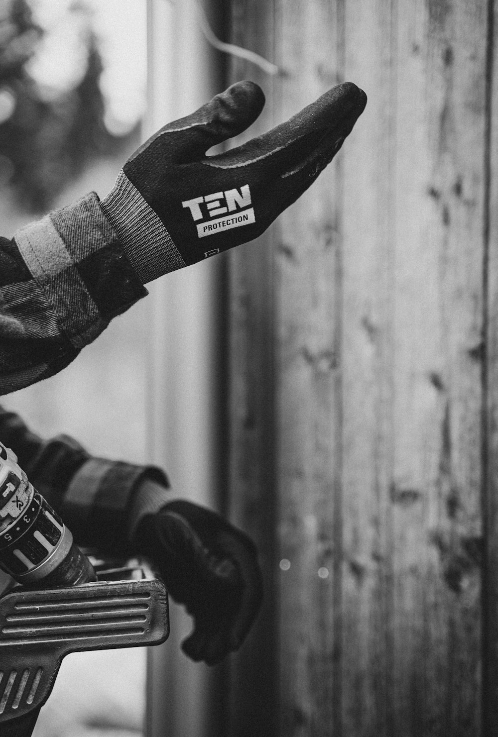 a black and white photo of a person riding a motorcycle