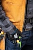 a close up of a person holding a tool belt
