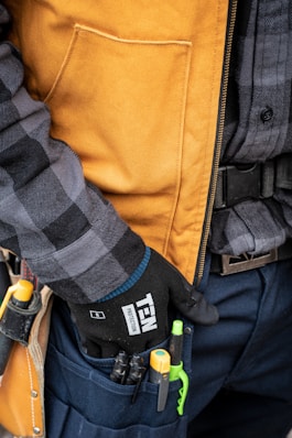 a close up of a person holding a tool belt