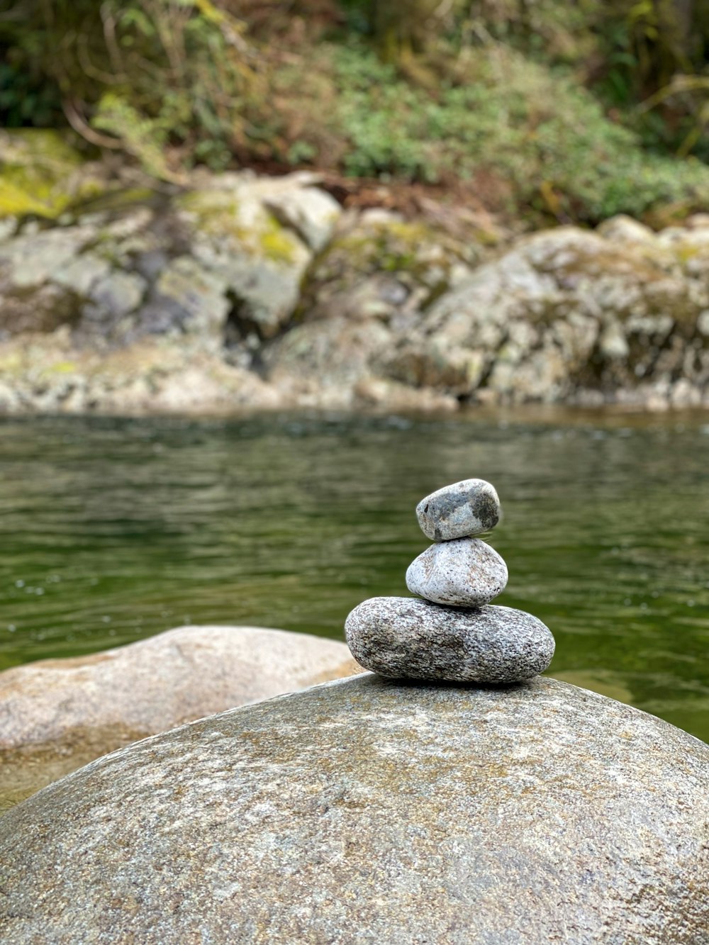 a pile of rocks sitting on top of a river