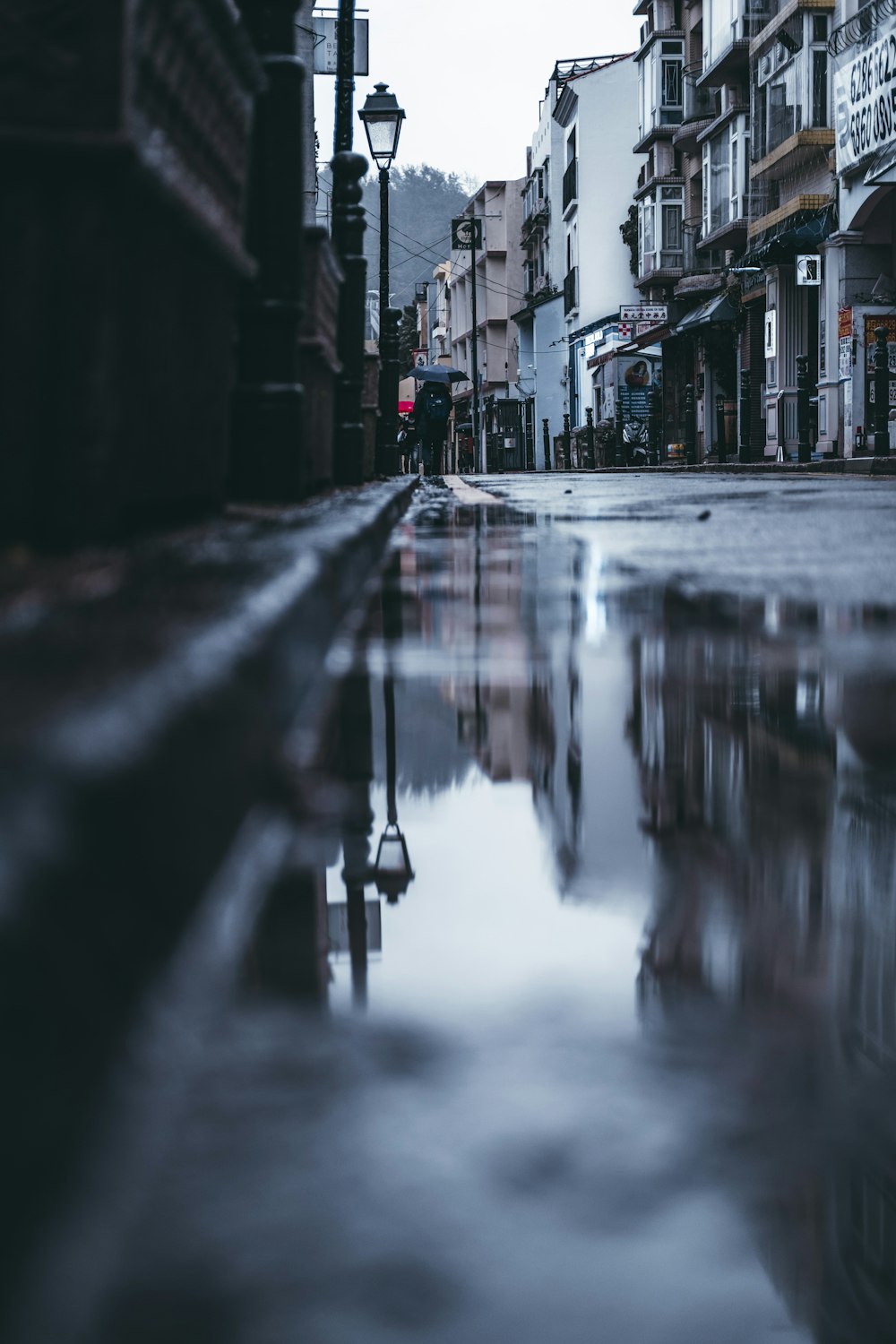 a city street with a puddle of water on the ground