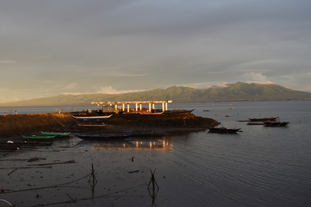 a group of boats sitting on top of a body of water