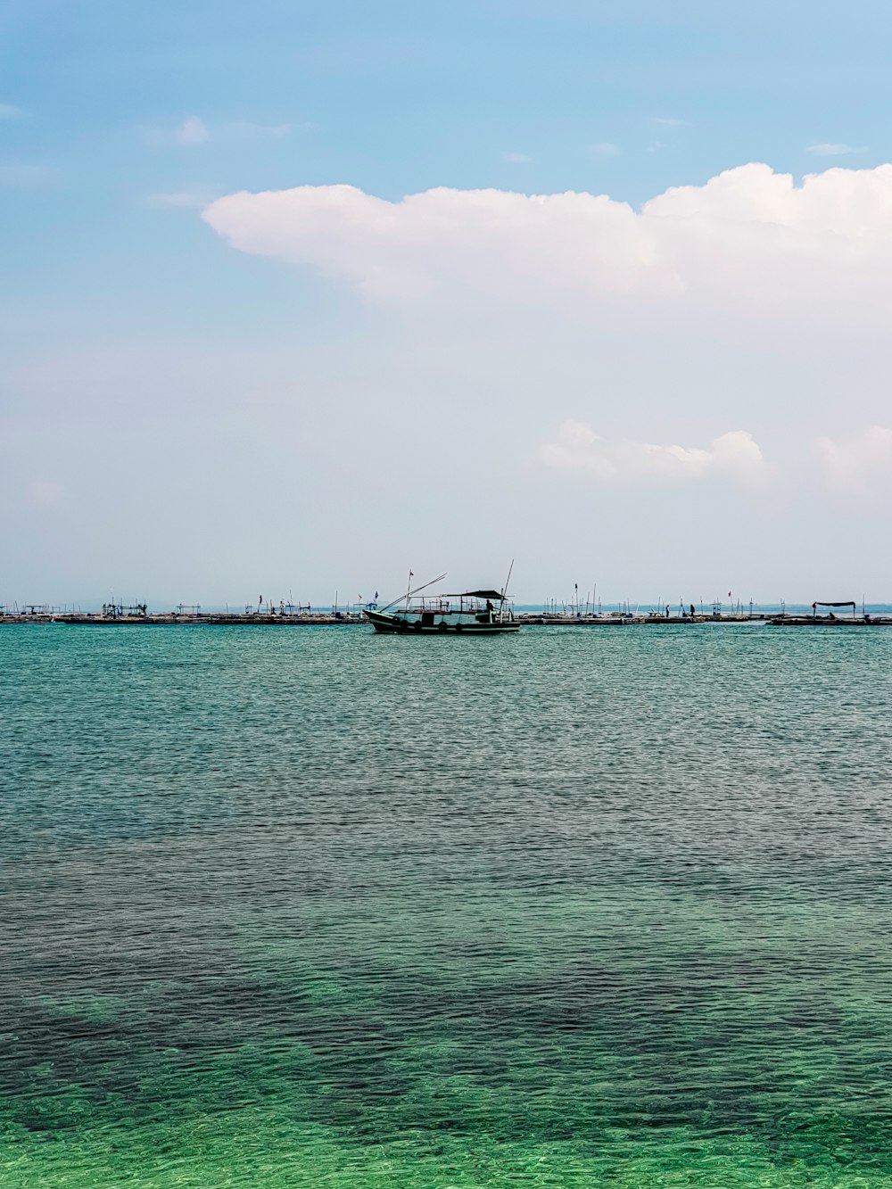 a boat floating on top of a large body of water