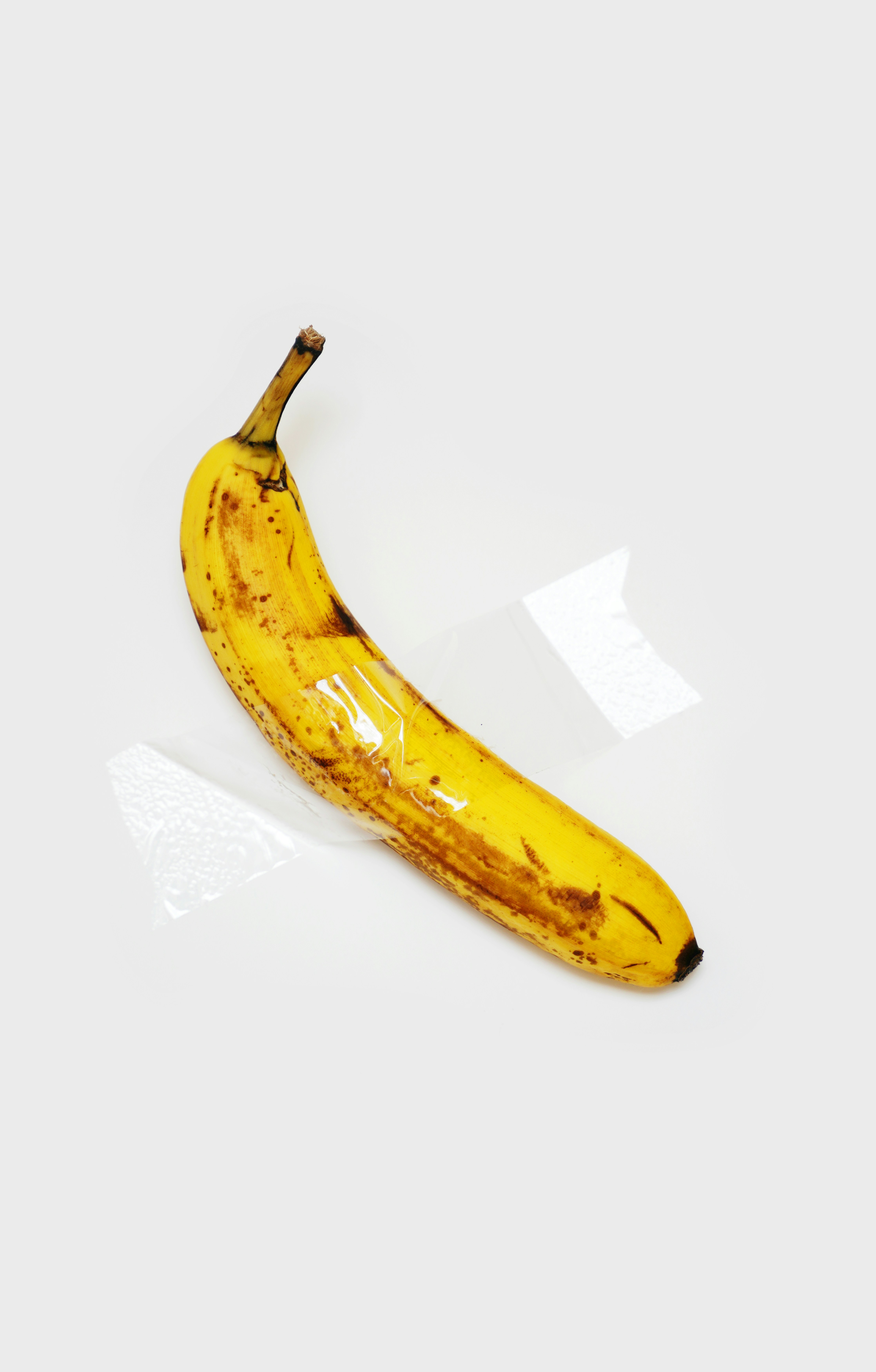 a ripe banana sitting on top of a white table