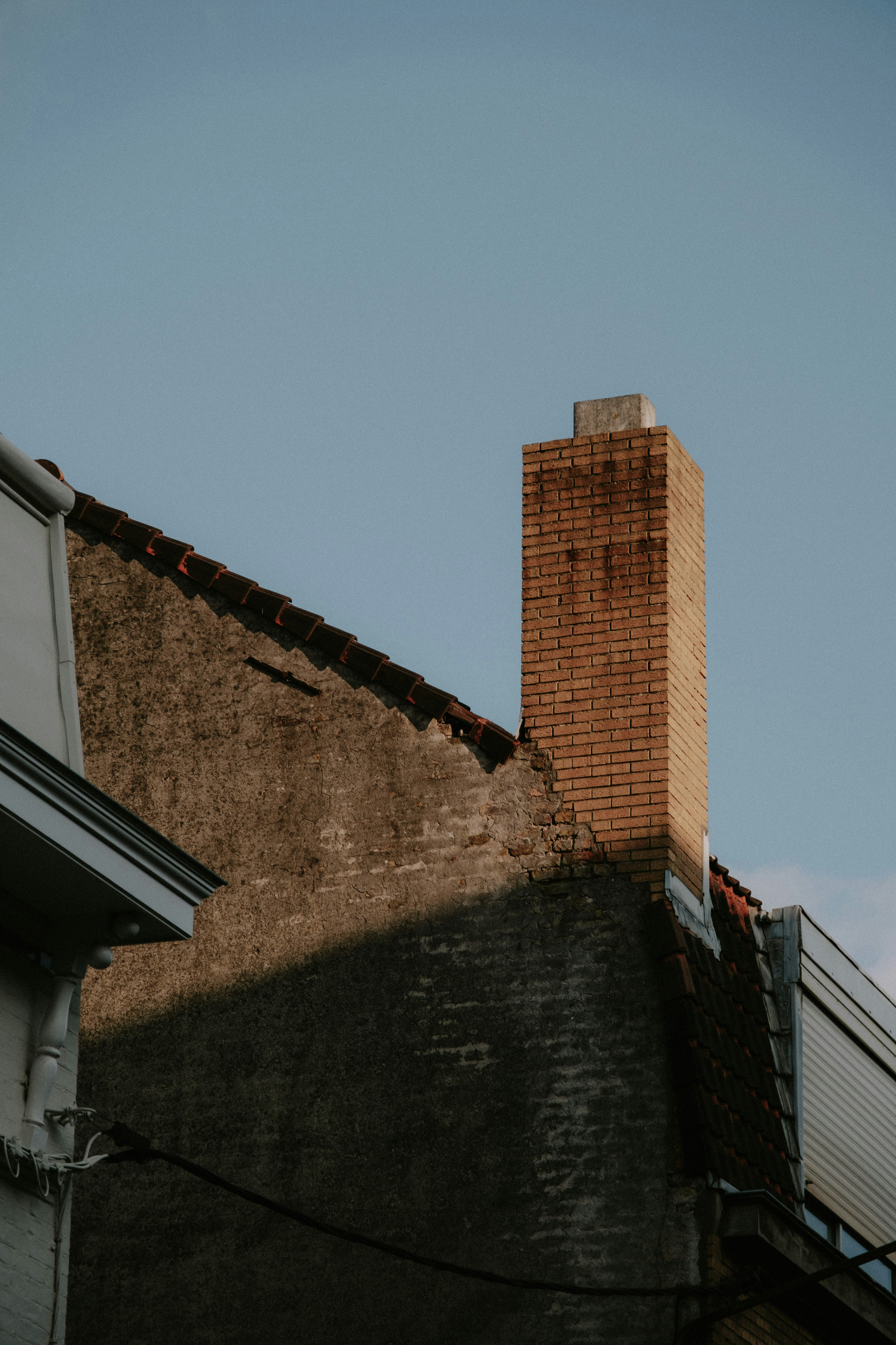 a brick chimney on the side of a building