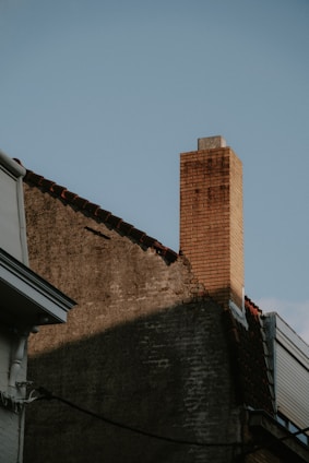 a brick chimney on the side of a building