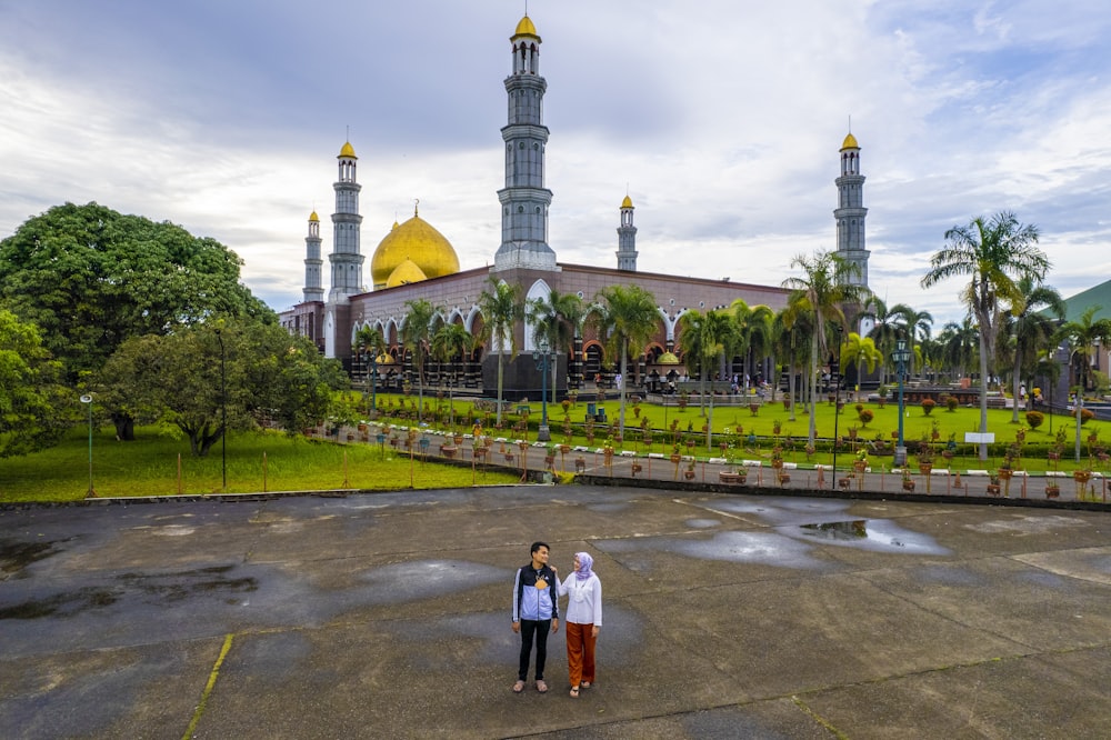 two women standing in front of a large building