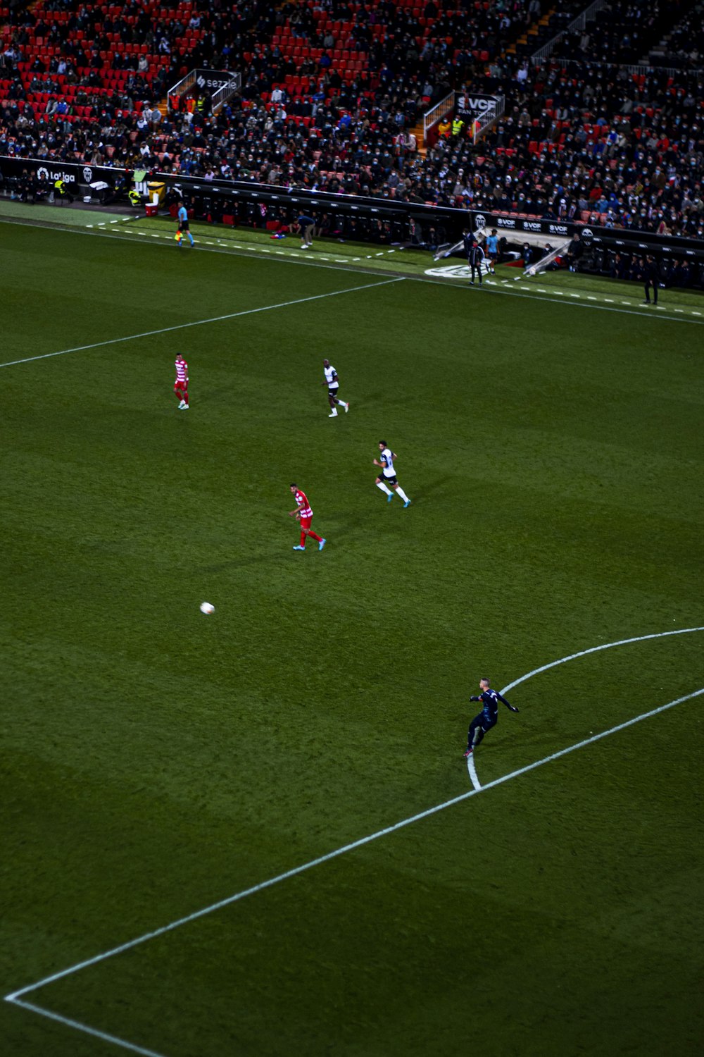 a group of people on a field playing soccer