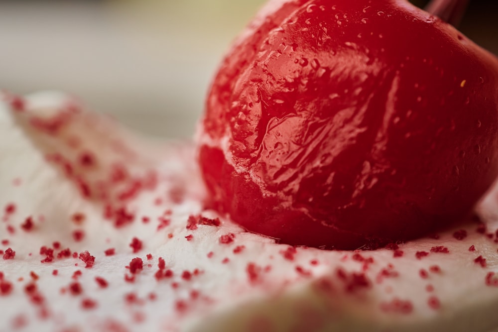 a close up of a piece of cake with red sprinkles