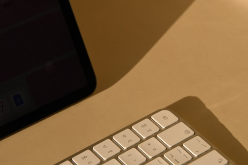 a computer keyboard sitting on top of a desk