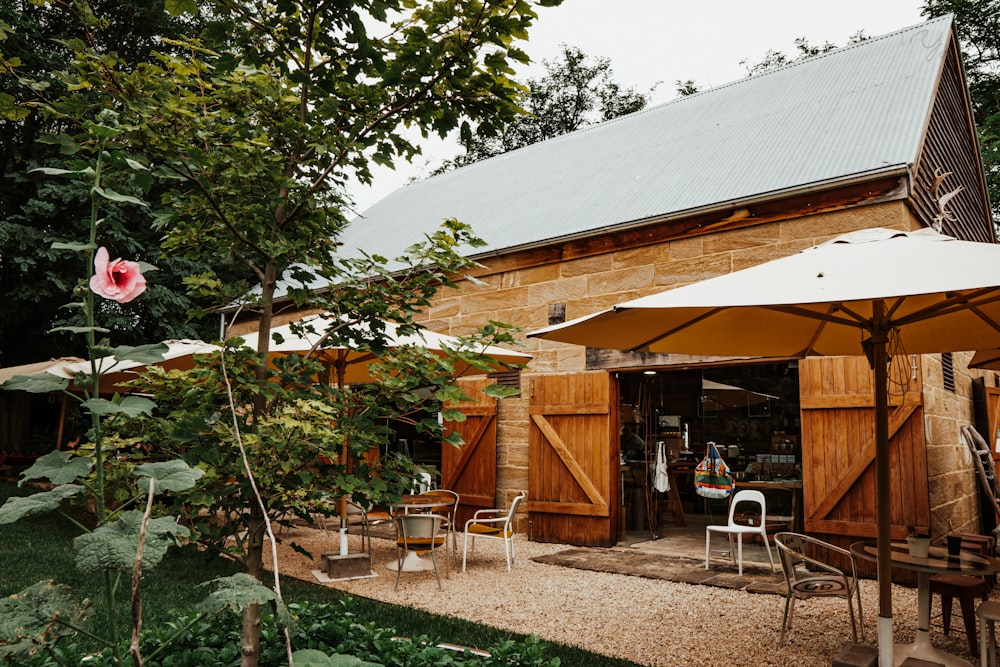 a building with a large umbrella and chairs outside of it