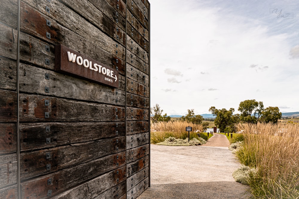 a wooden building with a sign on the side of it