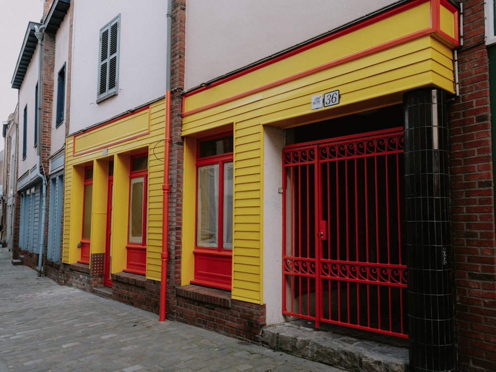 a row of buildings with red and yellow doors