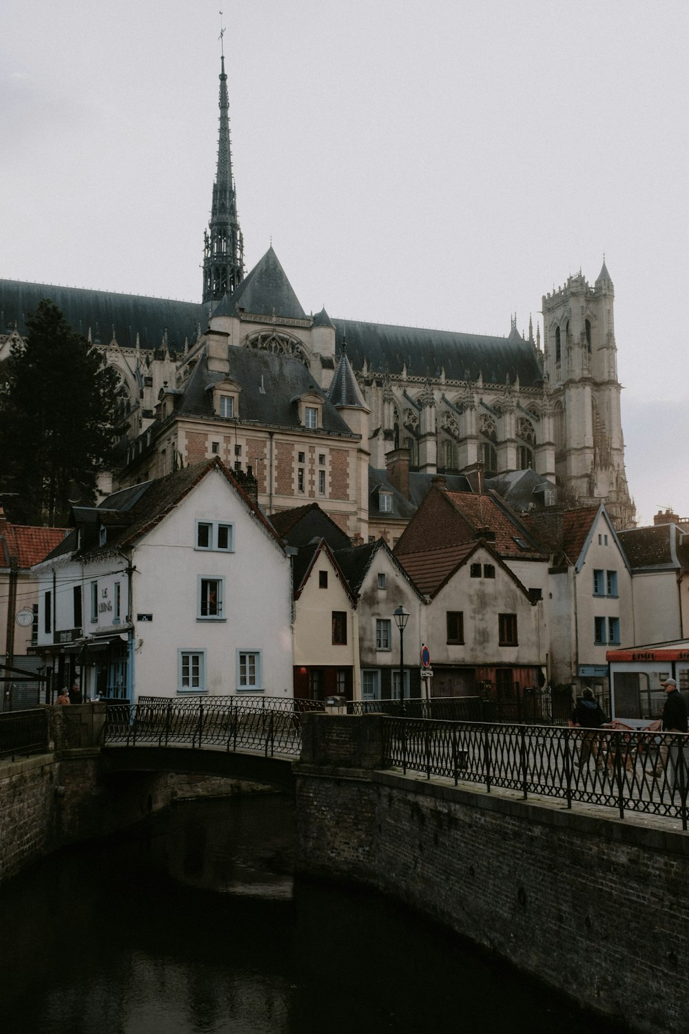 a bridge over a river with buildings in the background