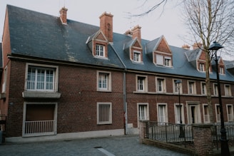 a brick building with a clock on the front of it