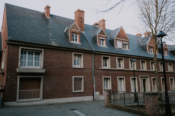 a brick building with a clock on the front of it