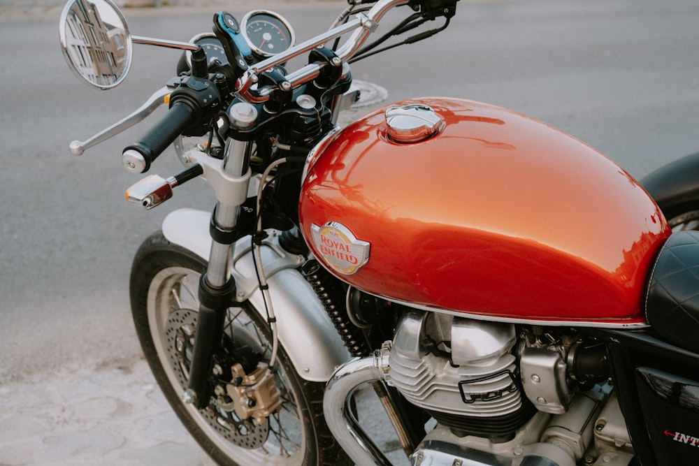 a red motorcycle parked on the side of the road