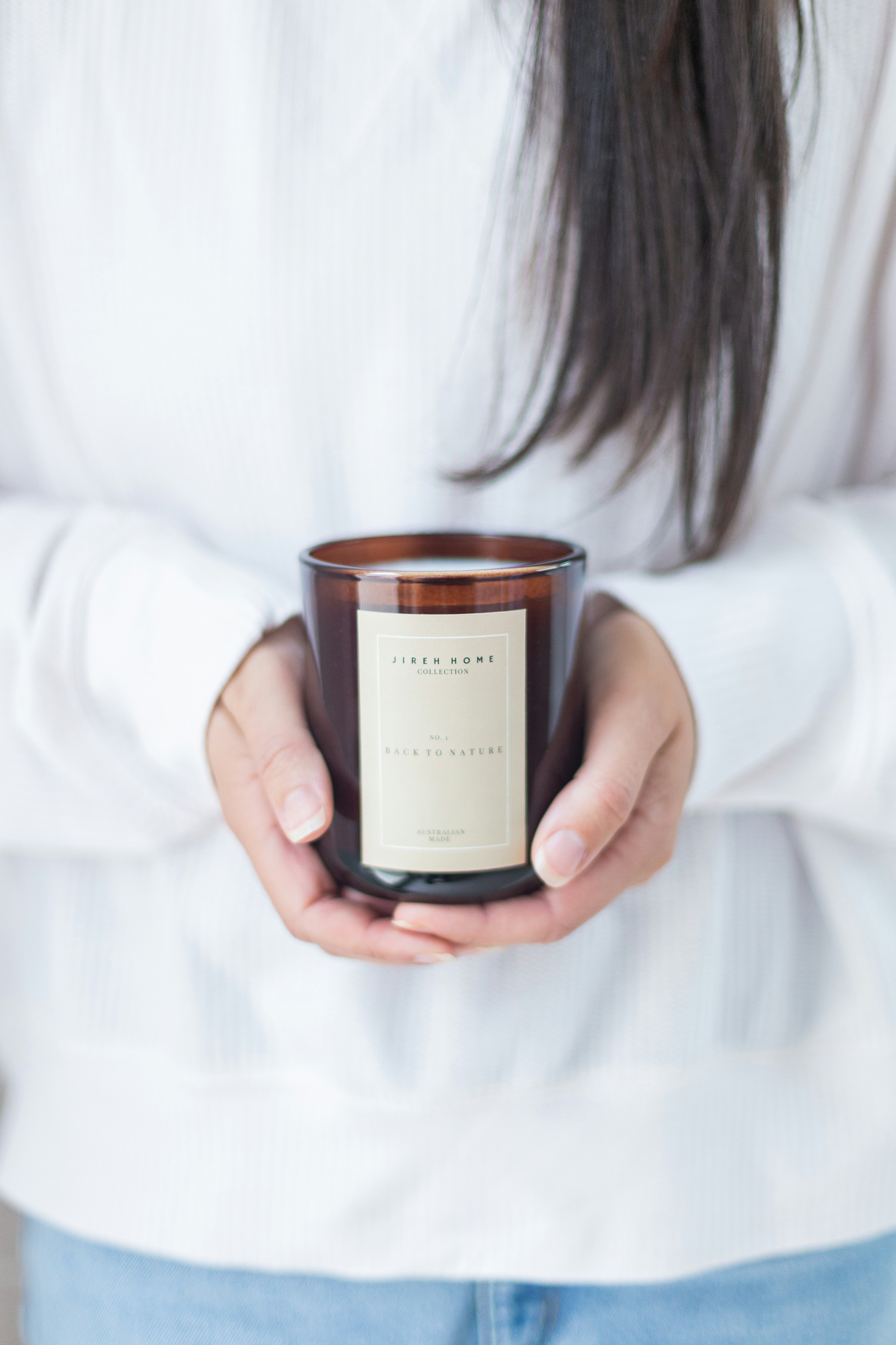 a woman holding a candle in her hands