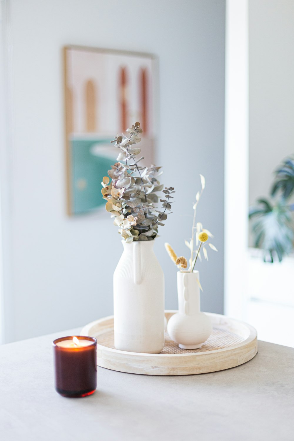 a couple of white vases sitting on top of a table