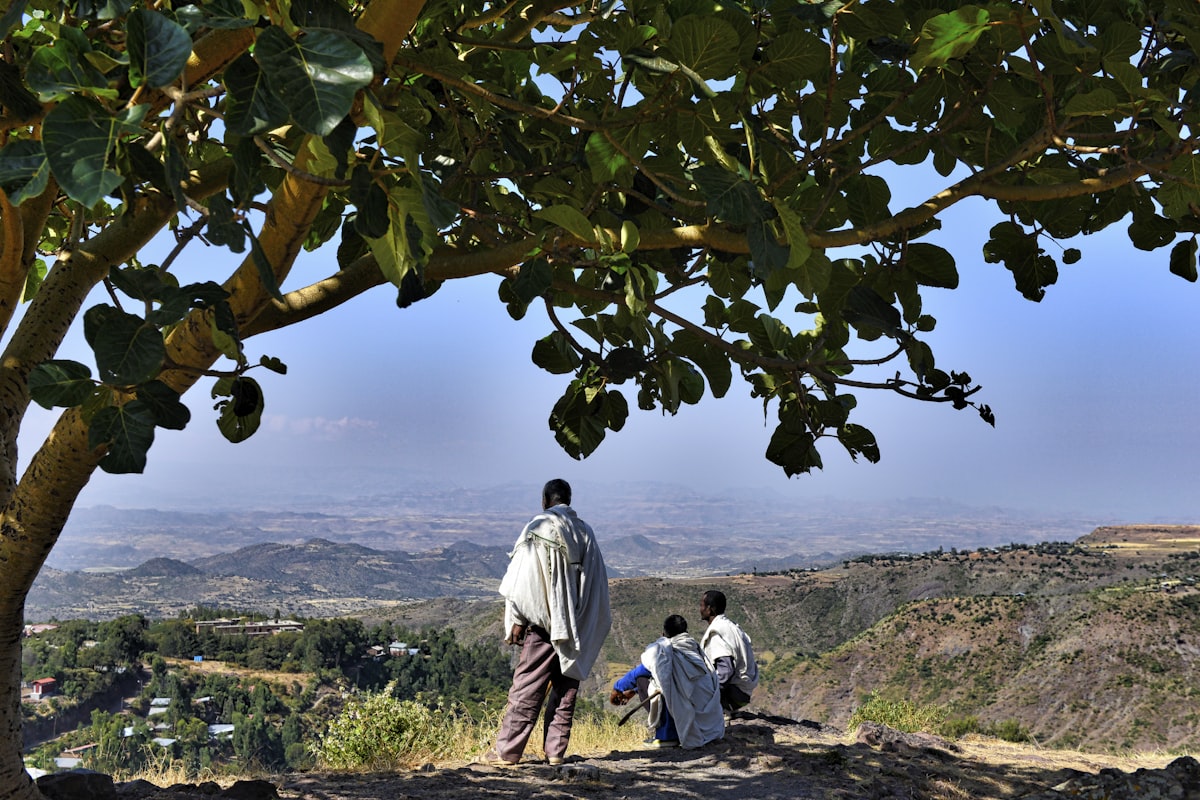 Lalibela May — two men standing on hilltop overlooking Ethiopian highland landscape