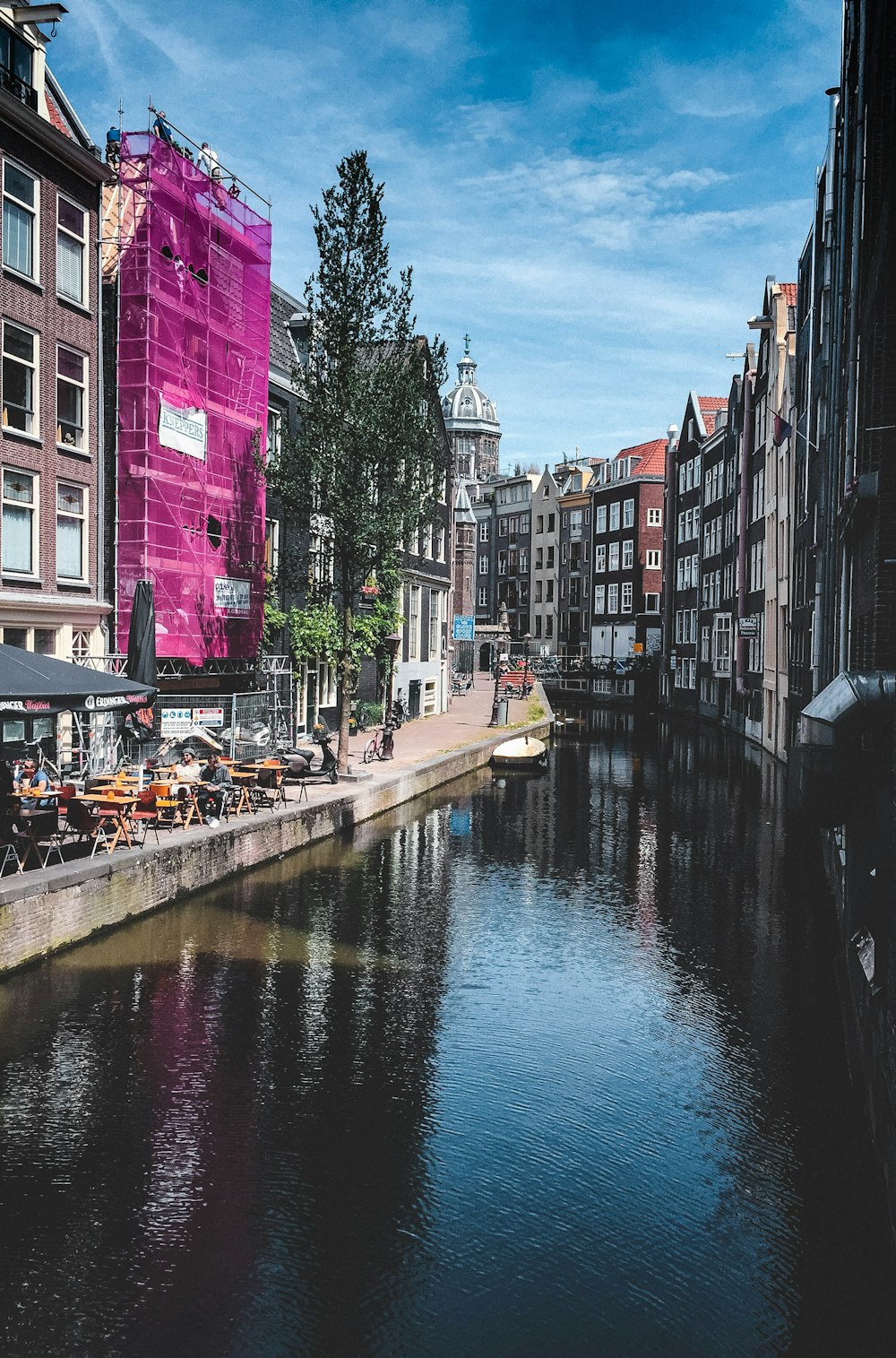 a river running through a city next to tall buildings