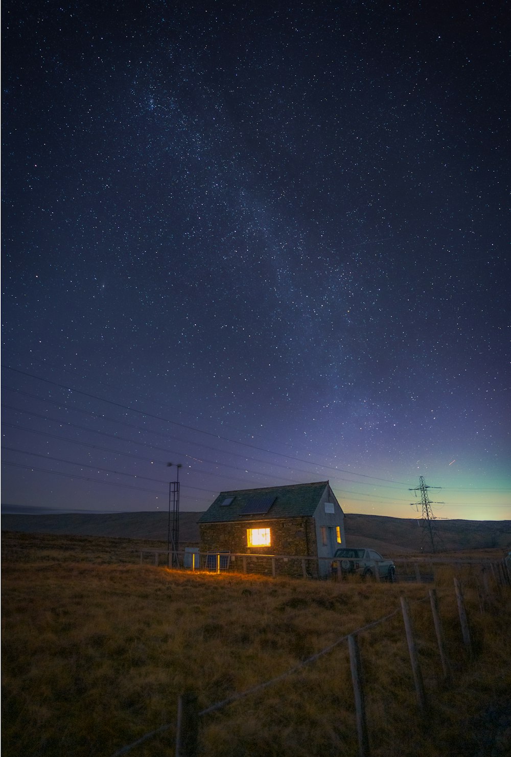 a small house sitting on top of a dry grass field