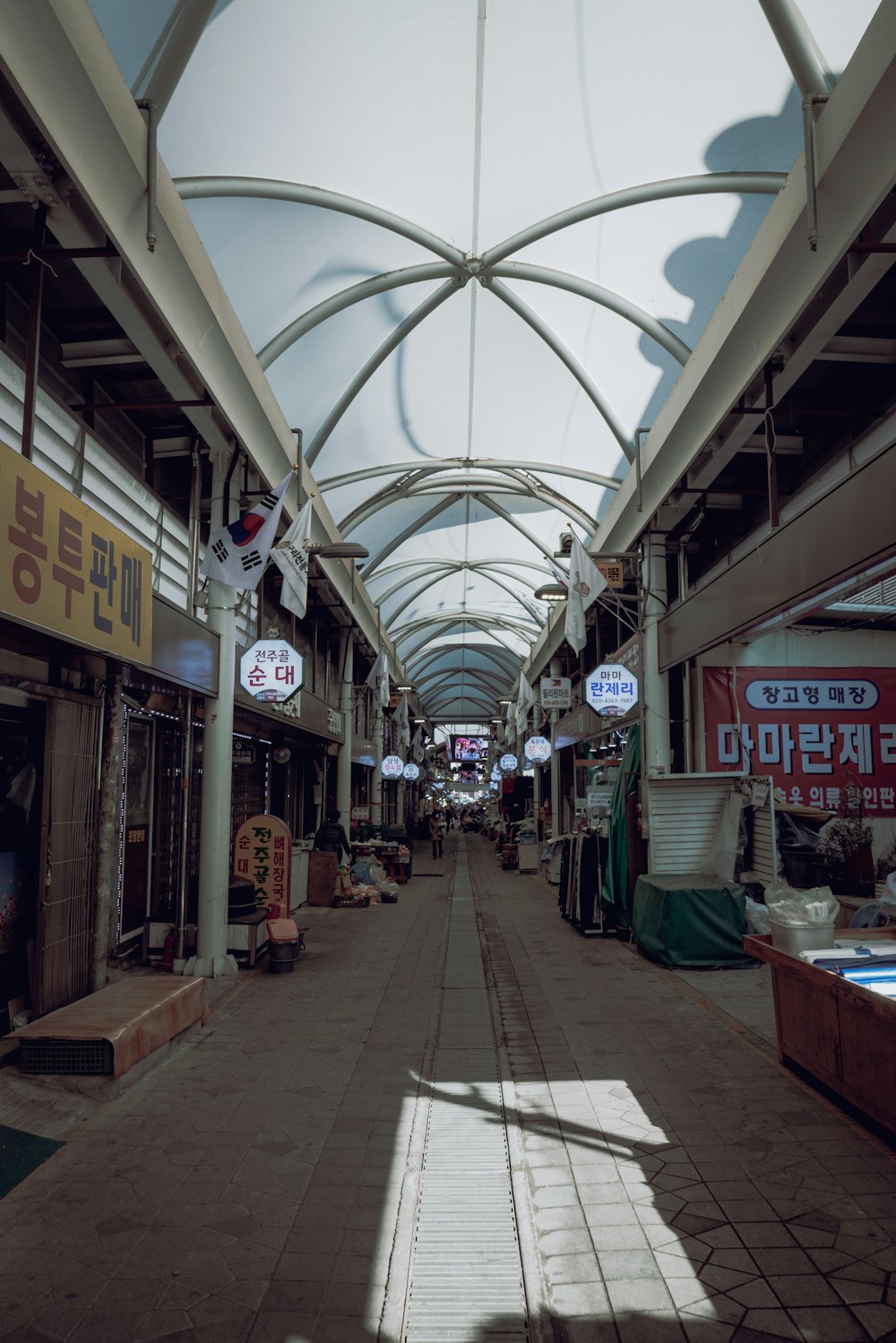 a street with a lot of shops and a skylight