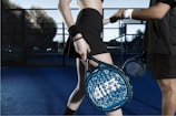 a woman holding a tennis racquet on top of a tennis court
