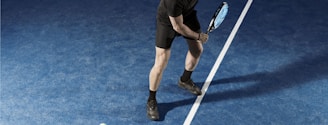 a man holding a tennis racquet on a tennis court