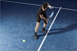 a man holding a tennis racquet on a tennis court