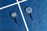two tennis rackets laying on a tennis court