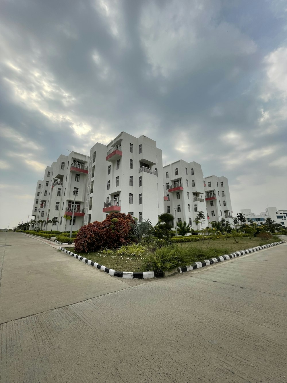 a large white building with red balconies on top of it