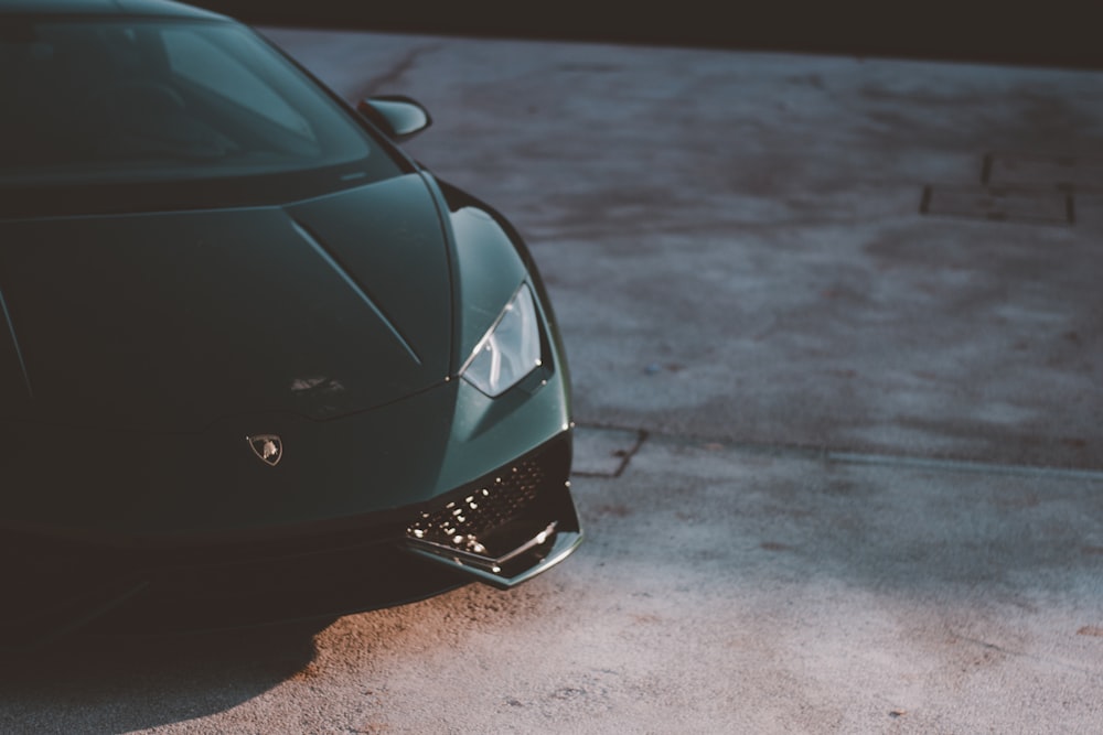 a green sports car parked in a parking lot