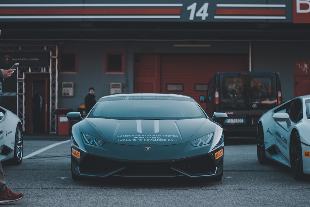 a man standing next to a blue sports car