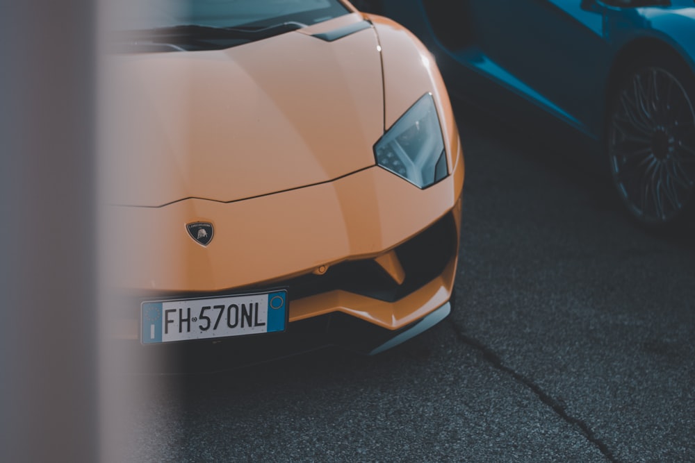 a close up of a sports car parked in a parking lot
