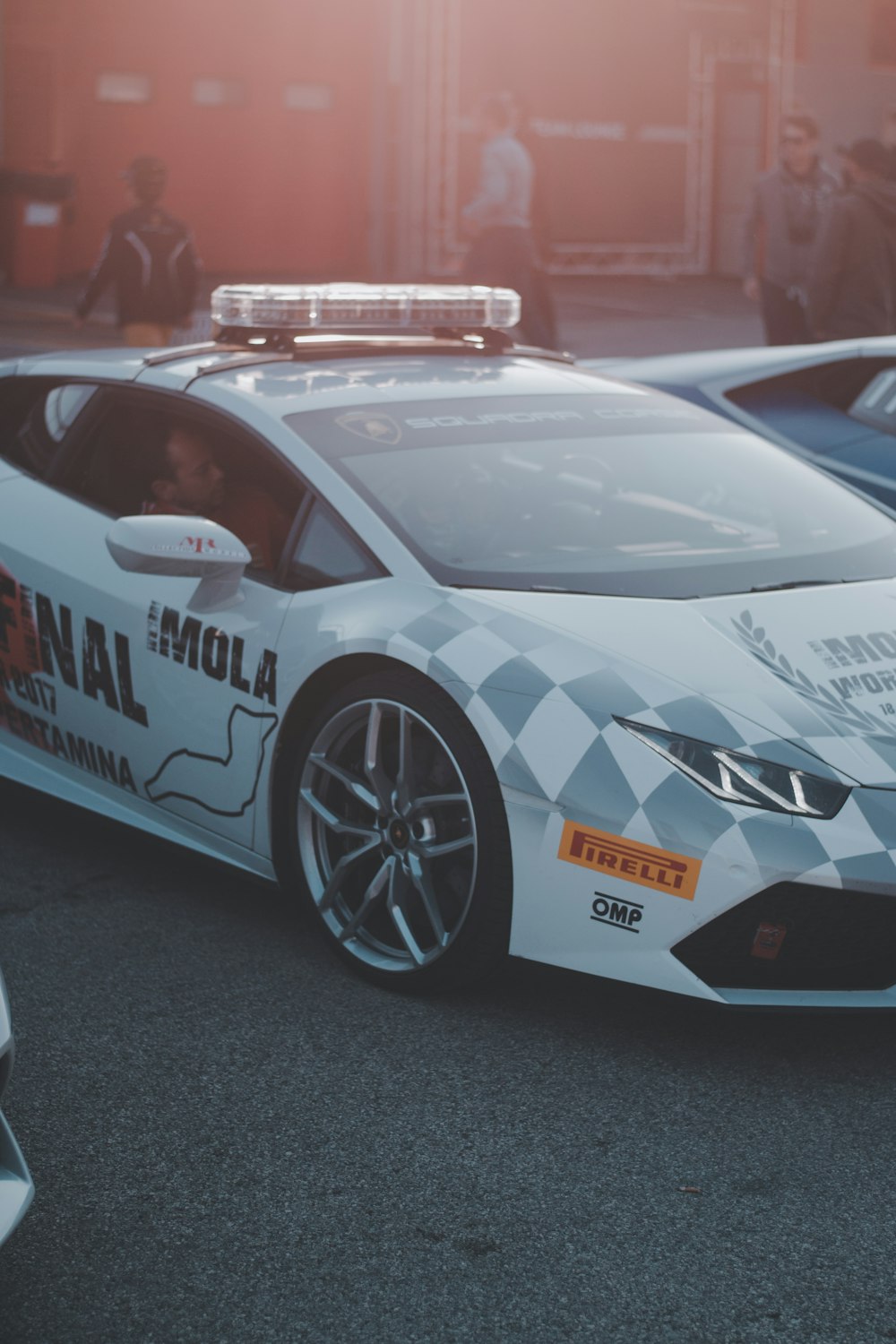 a police car parked in a parking lot next to other cars