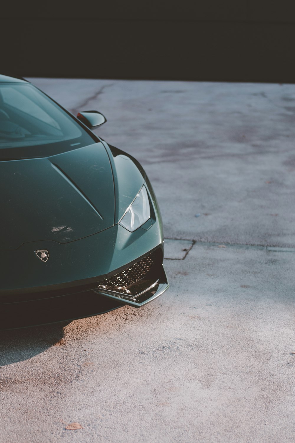 a green sports car parked in a parking lot