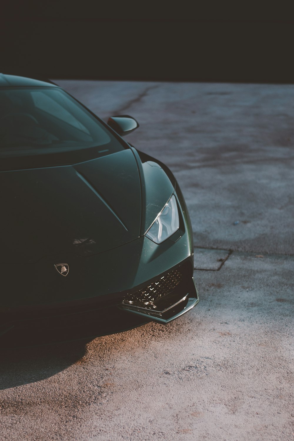 a green sports car parked in a parking lot