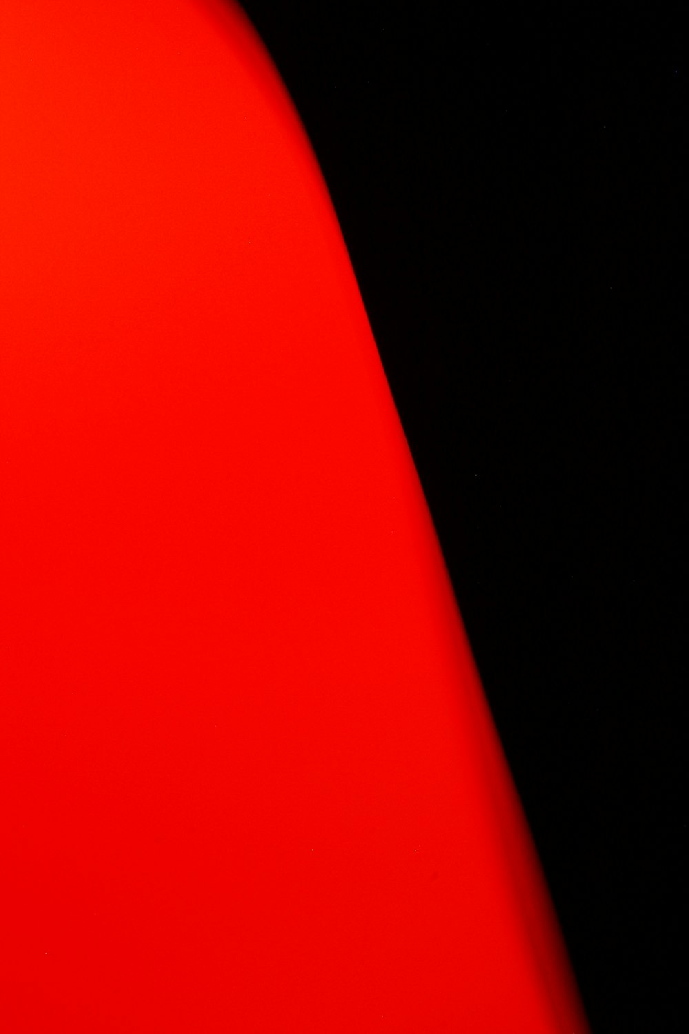 a close up of a red object with a black background