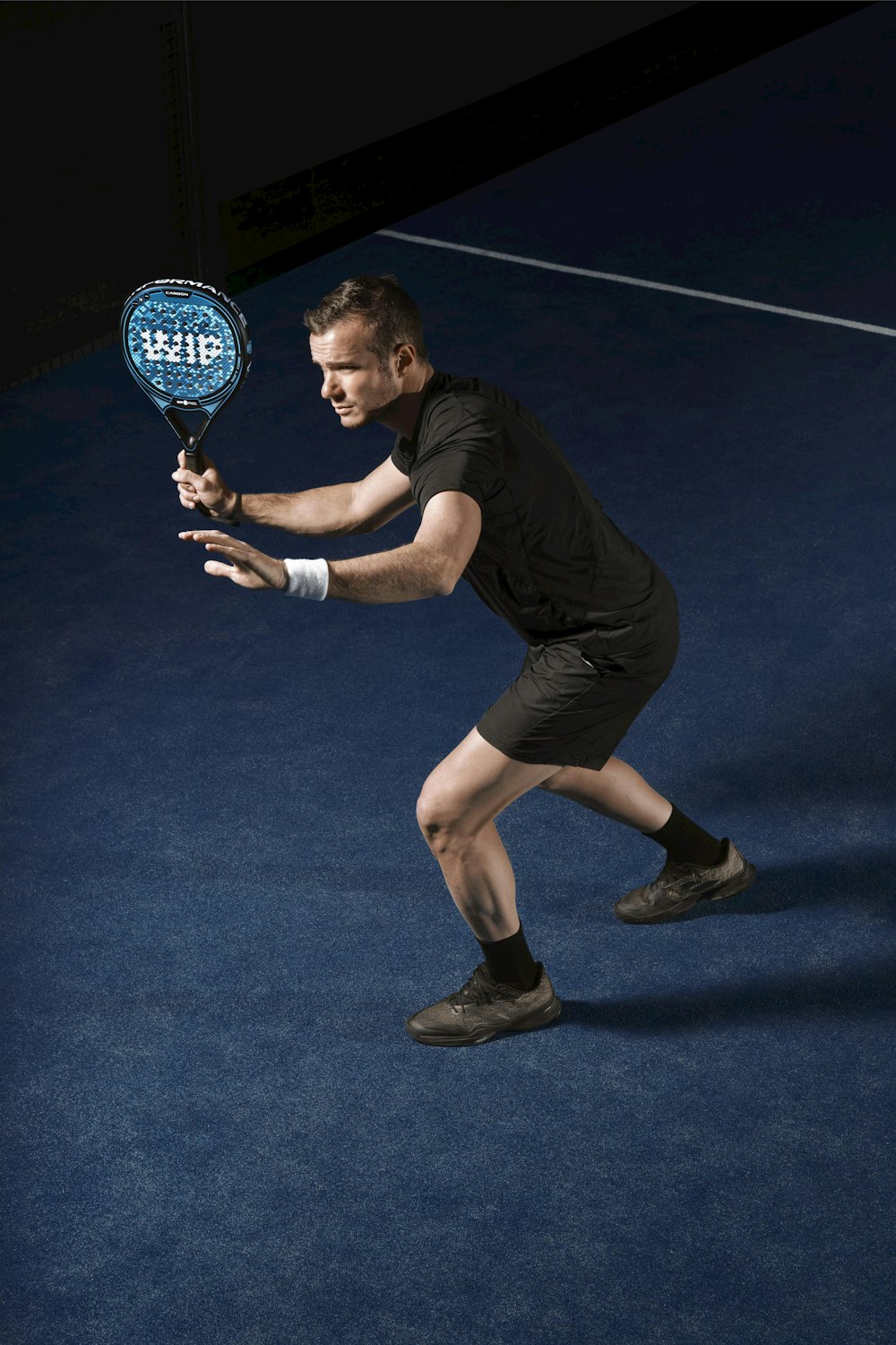 a man holding a tennis racquet on a tennis court