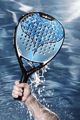 a person holding a tennis racket in the water