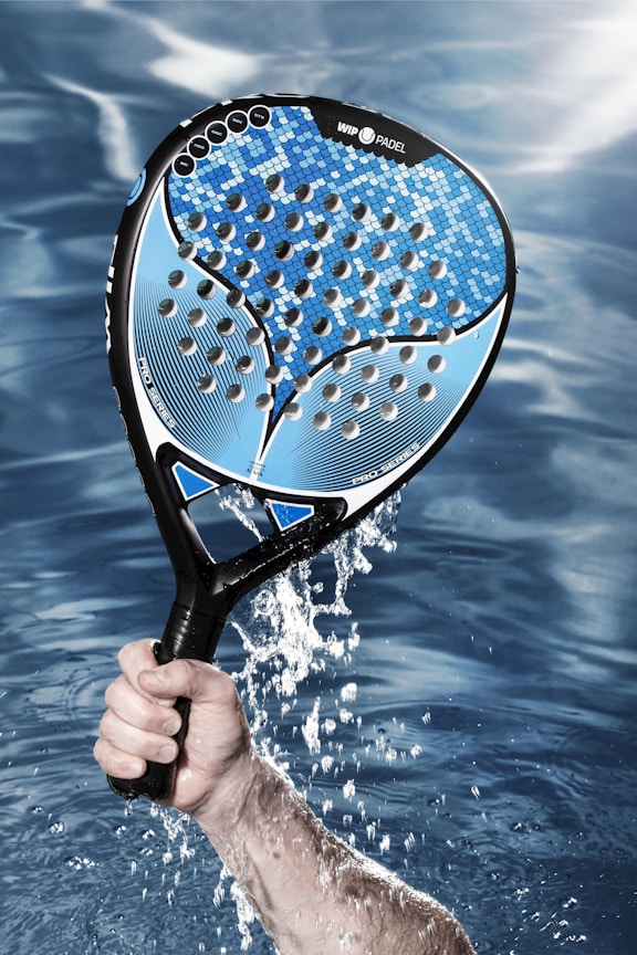 a person holding a tennis racket in the water