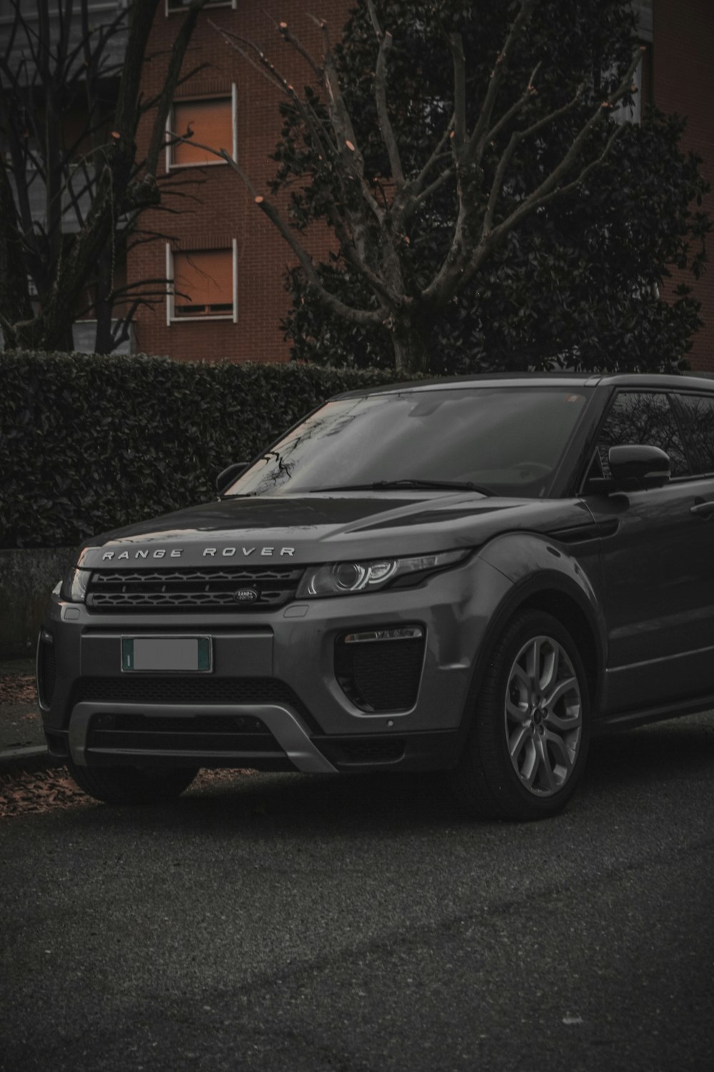a grey range rover parked on the side of the road