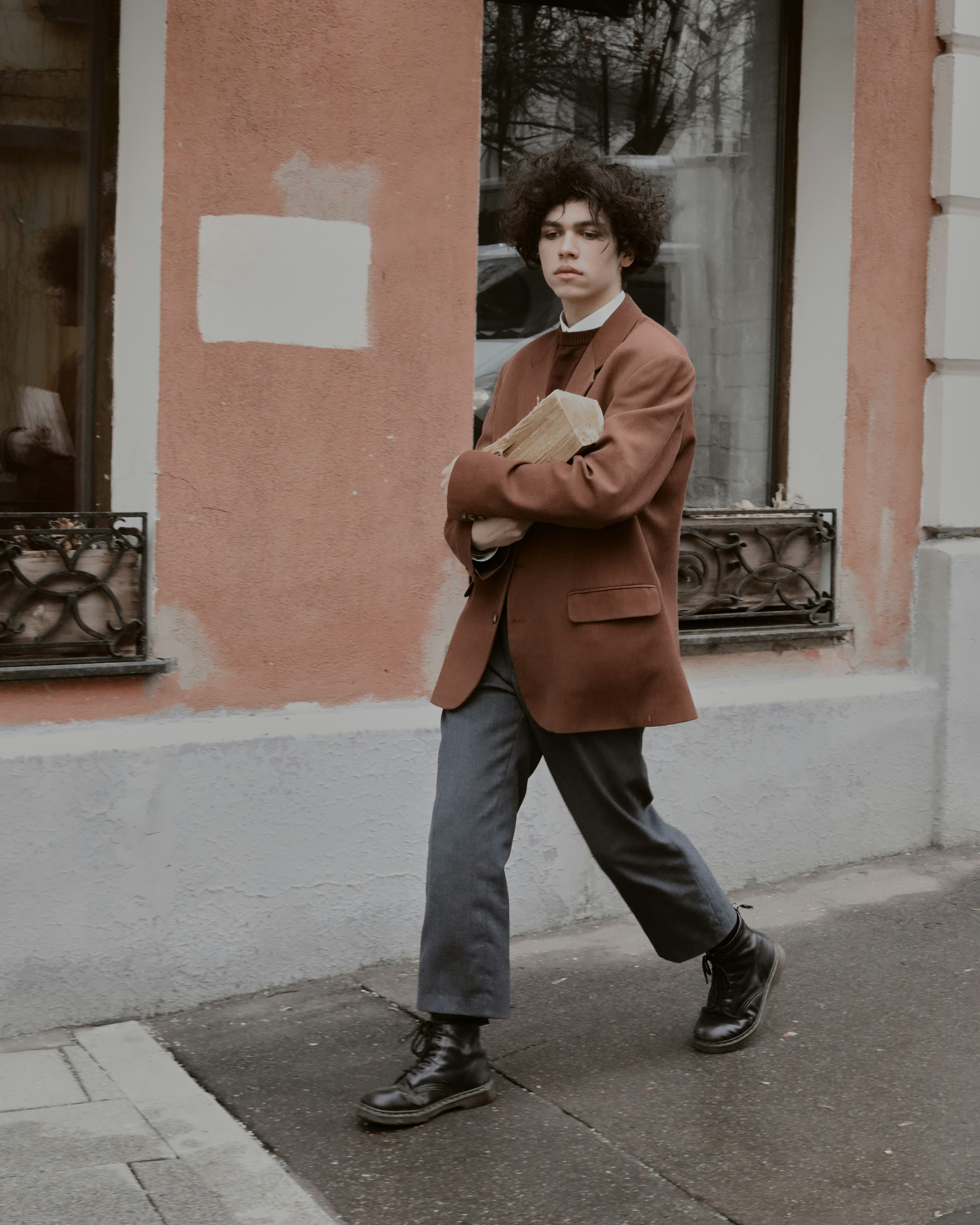 a person walking down the street talking on a cell phone
